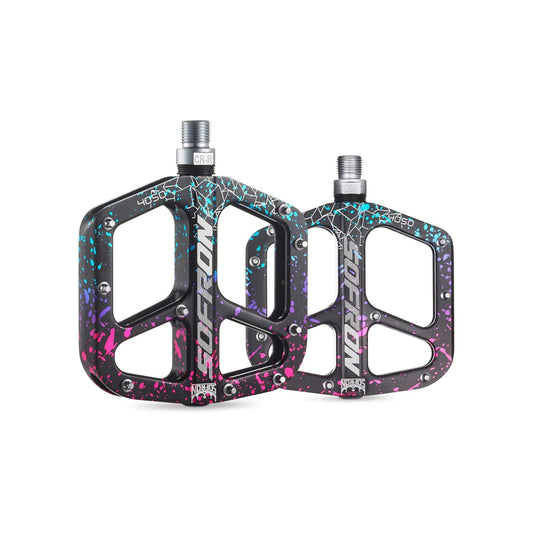 Alloy bicycle pedals in a rainbow camouflage pattern on a white background