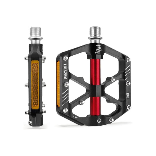 Black and red alloy bicycle pedals with built-in reflectors, shown from a side angle.