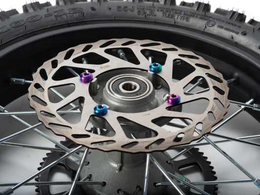 Close-up of the Stomp Ebox Titanium Wheel Dress Up Kit, showing a set of titanium wheel bolts and washers arranged neatly on a white background.