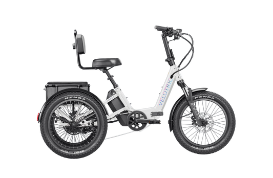 Pearl white Velotric Triker eTrike, side view, showcasing three wheels and modern frame design.