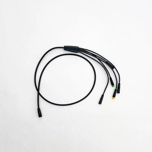 Close-up view of a Super73 R/RX/S2 e-bike wiring harness, showing multiple colored wires, connectors, and plugs arranged for electrical connections.