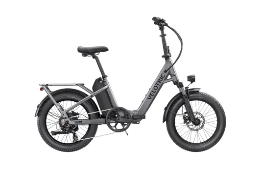 Stone gray Velotric Fold 1 electric bike shown folded, highlighting its compact design and sturdy frame.